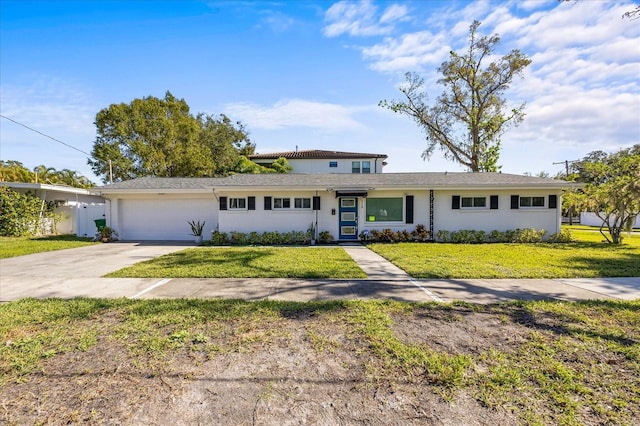 view of front of home with a front lawn and a garage