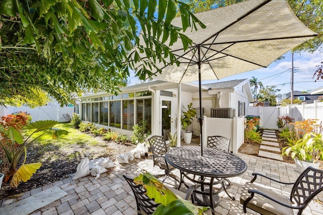 view of patio / terrace featuring a sunroom