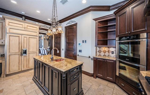 kitchen featuring ornamental molding, stainless steel double oven, sink, cream cabinets, and an inviting chandelier