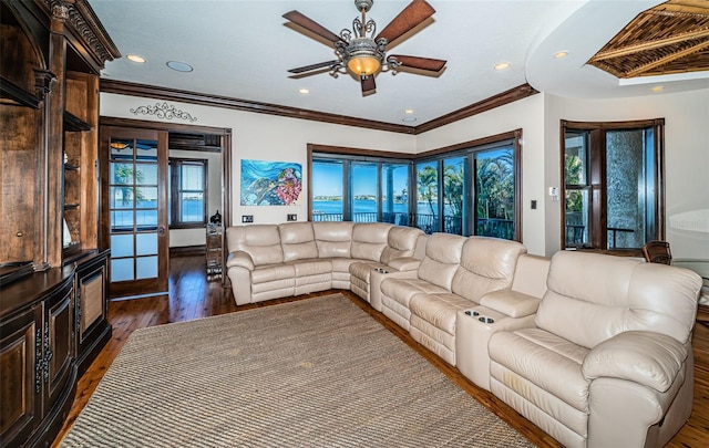 living room with dark hardwood / wood-style floors, ceiling fan, and crown molding