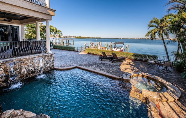 exterior space featuring a balcony, a water view, and a patio