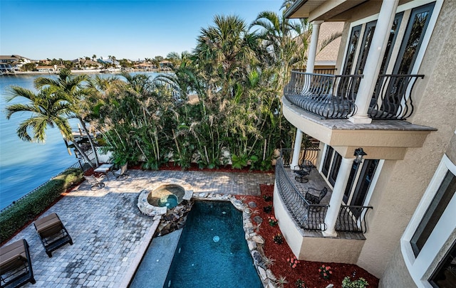 view of patio / terrace featuring a water view and a balcony