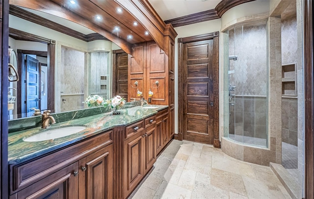 bathroom featuring a tile shower, crown molding, and vanity