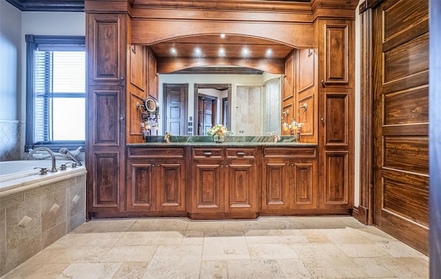 bathroom with wooden walls, vanity, and tiled bath