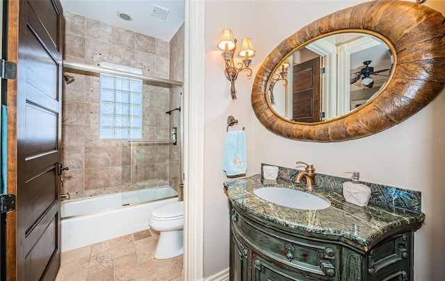 full bathroom with vanity, ceiling fan, toilet, and enclosed tub / shower combo