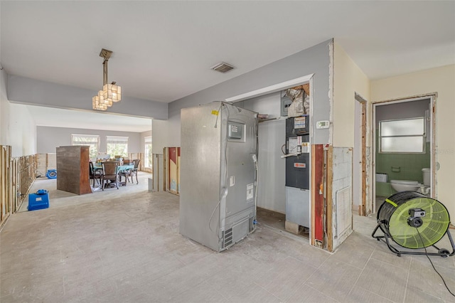 corridor featuring heating unit and tile walls