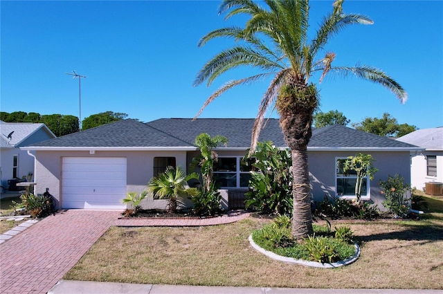 ranch-style home with a garage and a front yard