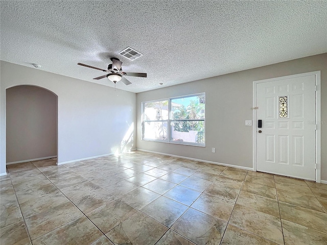 interior space featuring ceiling fan and a textured ceiling