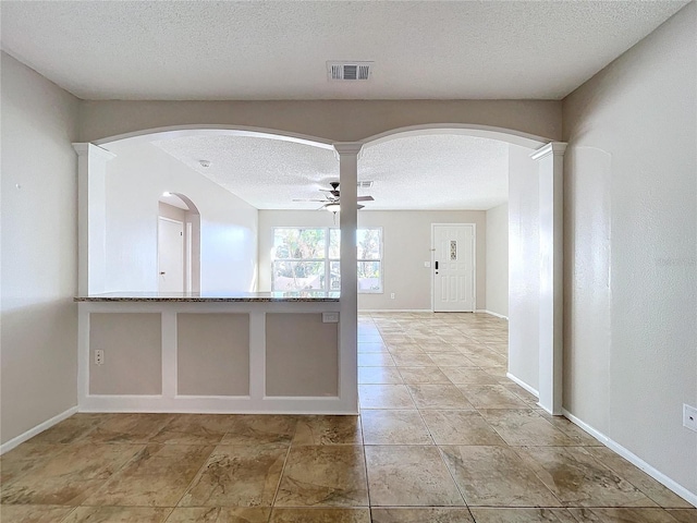 kitchen featuring ceiling fan and a textured ceiling