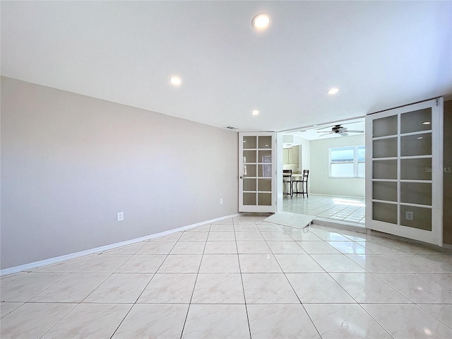 tiled empty room with ceiling fan and french doors