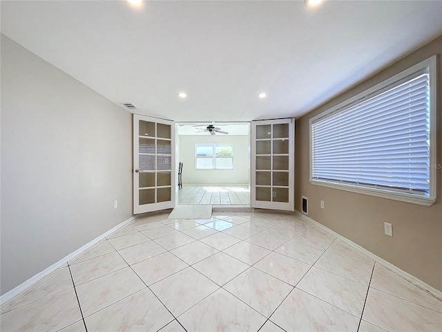 unfurnished room featuring french doors, light tile patterned floors, and ceiling fan