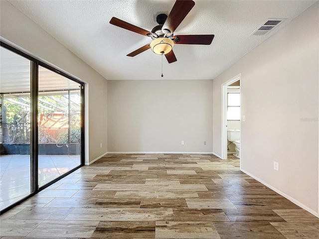 unfurnished room featuring ceiling fan, a healthy amount of sunlight, a textured ceiling, and light hardwood / wood-style flooring