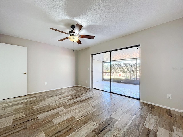 unfurnished room featuring ceiling fan, a textured ceiling, and light wood-type flooring