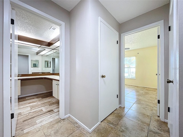 corridor with a textured ceiling