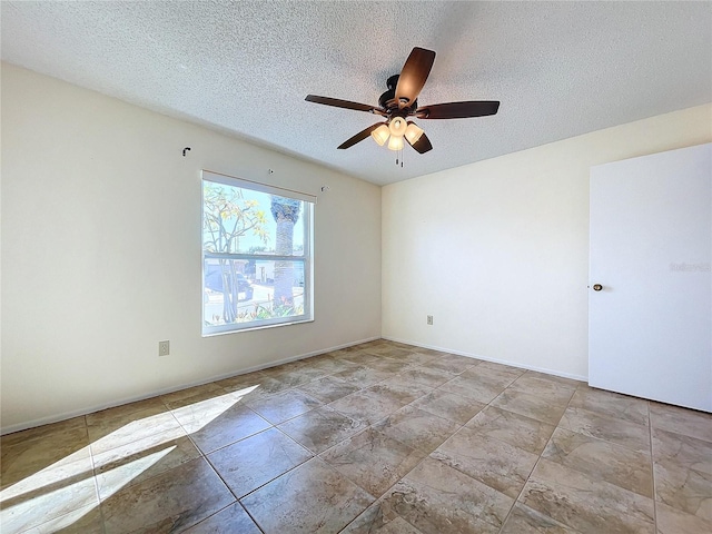 spare room featuring ceiling fan and a textured ceiling