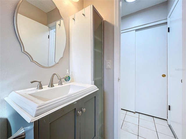 bathroom featuring tile patterned flooring and vanity