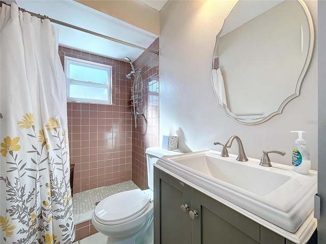 bathroom with toilet, vanity, and a shower with shower curtain