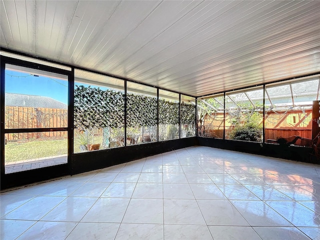 unfurnished sunroom featuring a mountain view and wooden ceiling