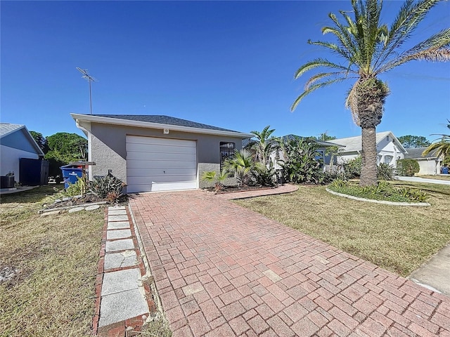 view of front of property featuring a garage and a front yard