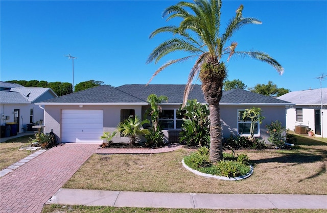 ranch-style home with a garage and a front yard