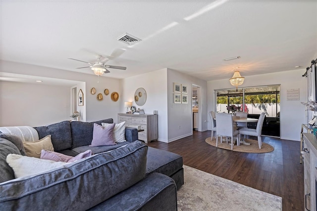 living room with ceiling fan and dark wood-type flooring