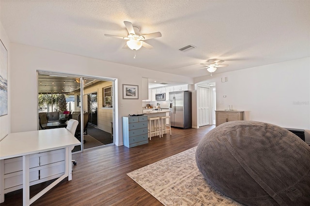 interior space featuring a textured ceiling, dark hardwood / wood-style floors, and ceiling fan