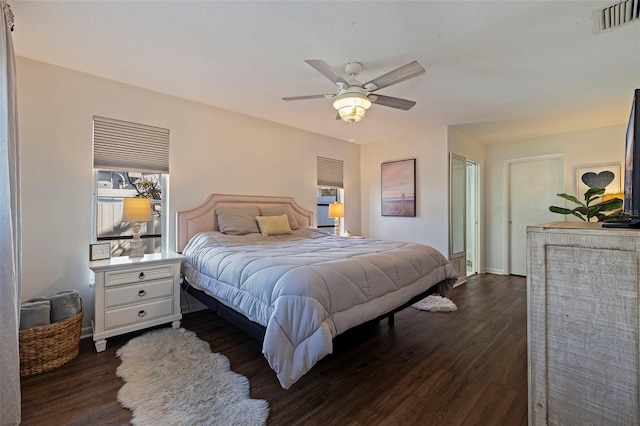 bedroom with ceiling fan and dark wood-type flooring