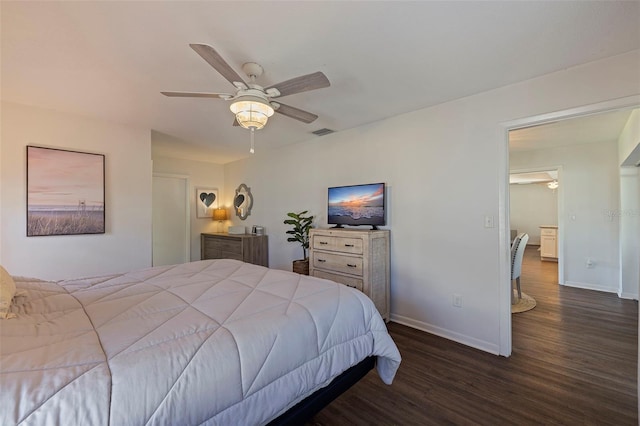 bedroom with dark hardwood / wood-style flooring and ceiling fan