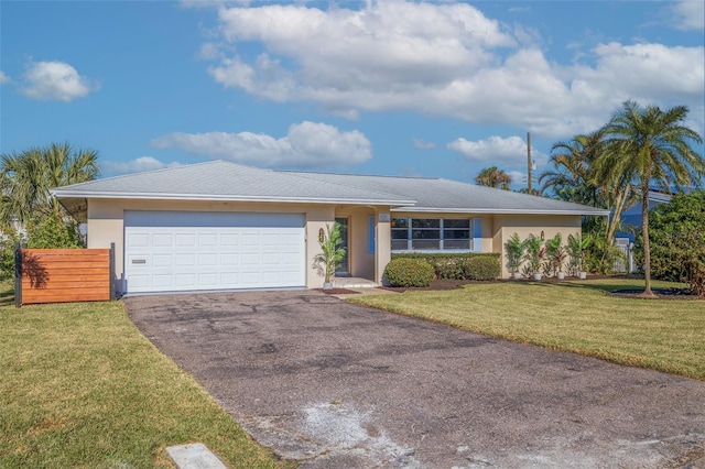 ranch-style home featuring a garage and a front lawn