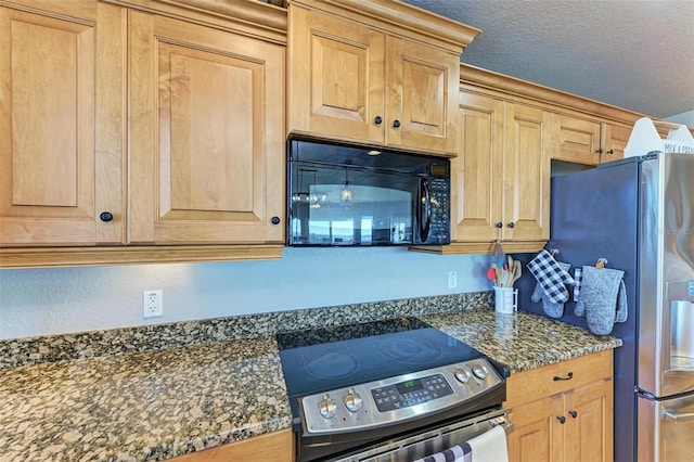 kitchen featuring dark stone countertops, a textured ceiling, and appliances with stainless steel finishes