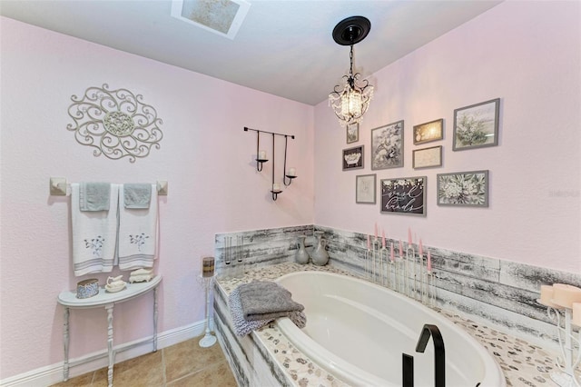 bathroom with tile patterned flooring, a relaxing tiled tub, and a notable chandelier