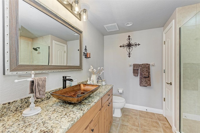 bathroom featuring vanity, tile patterned flooring, toilet, a textured ceiling, and a shower with shower door