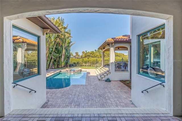 view of pool featuring an in ground hot tub and a patio area