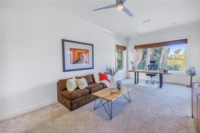 living room featuring light carpet, plenty of natural light, ceiling fan, and ornamental molding