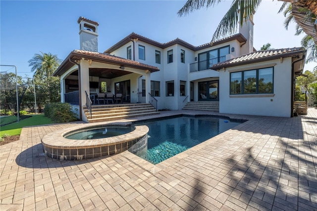 view of swimming pool with an in ground hot tub and a patio