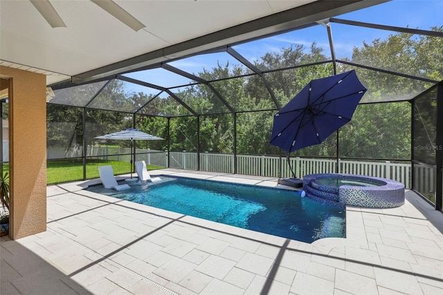 view of swimming pool with an in ground hot tub, glass enclosure, and a patio area