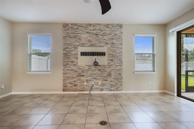 spare room featuring ceiling fan and light tile patterned flooring