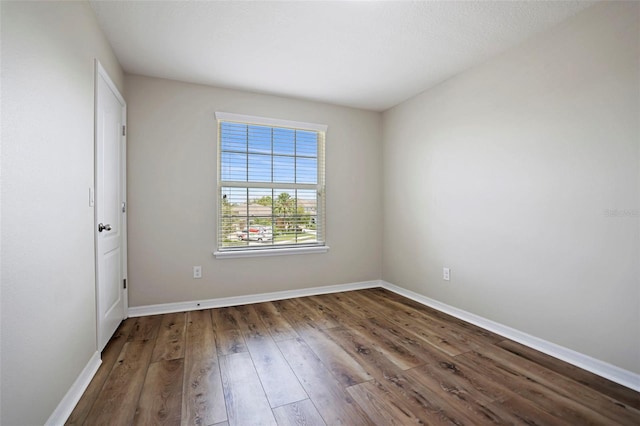 unfurnished room with wood-type flooring