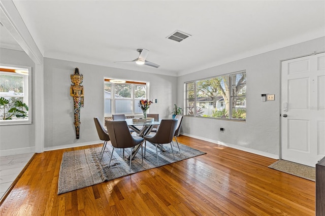 dining area featuring light wood-type flooring, ceiling fan, and ornamental molding