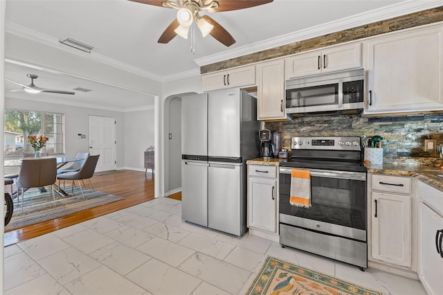 kitchen with decorative backsplash, crown molding, white cabinetry, and stainless steel appliances