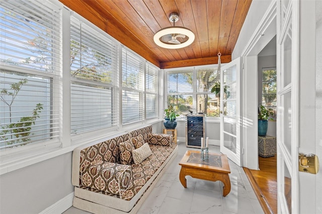 sunroom / solarium featuring wine cooler and wood ceiling