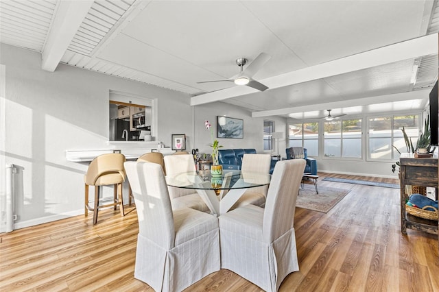 dining space featuring vaulted ceiling with beams, ceiling fan, and wood-type flooring