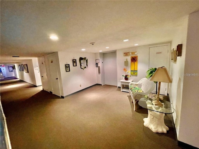 sitting room featuring carpet and a textured ceiling