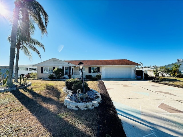 ranch-style house featuring a garage and a front lawn