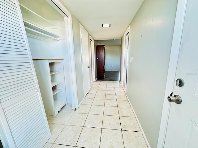 hall featuring light tile patterned floors