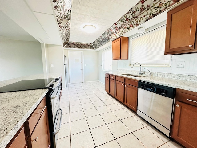 kitchen with dishwasher, black electric range oven, sink, light tile patterned floors, and light stone counters