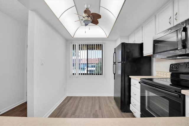 kitchen with decorative backsplash, light wood-type flooring, ceiling fan, black appliances, and white cabinets