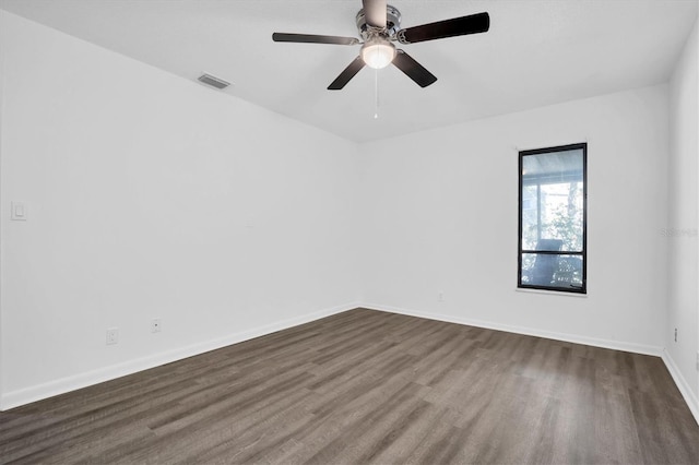 unfurnished room with ceiling fan and dark hardwood / wood-style flooring