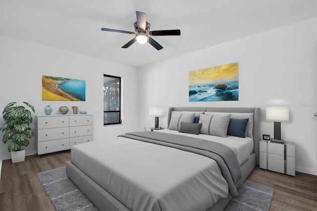 bedroom with dark hardwood / wood-style floors and ceiling fan