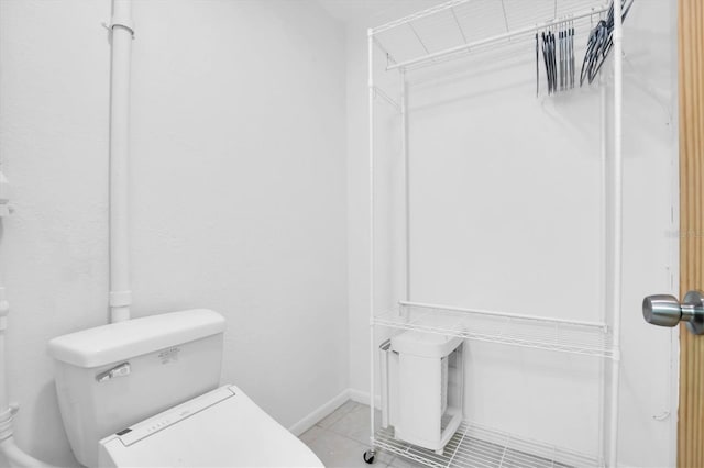 bathroom featuring tile patterned flooring and toilet